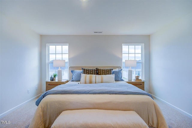 carpeted bedroom with multiple windows