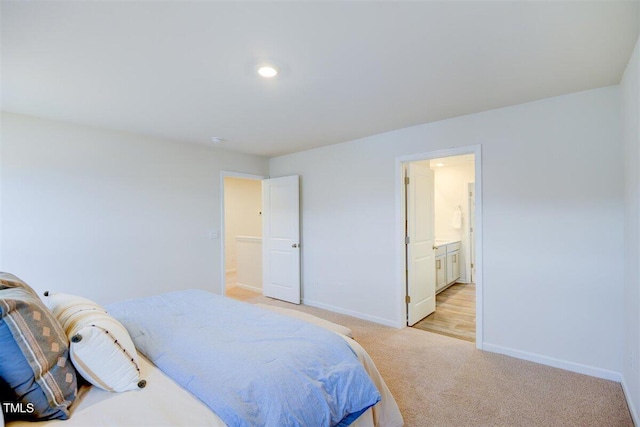 carpeted bedroom with ensuite bathroom