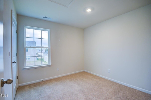 unfurnished room featuring light carpet