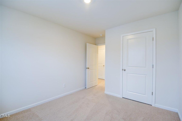 unfurnished bedroom featuring light carpet