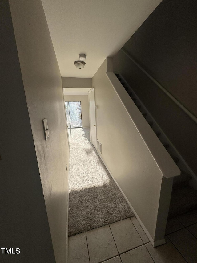 corridor with light colored carpet