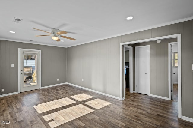 spare room with dark hardwood / wood-style floors, ceiling fan, and crown molding