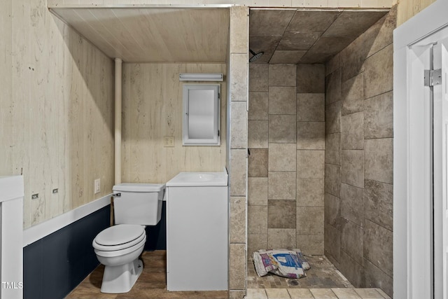 bathroom with wooden walls and toilet