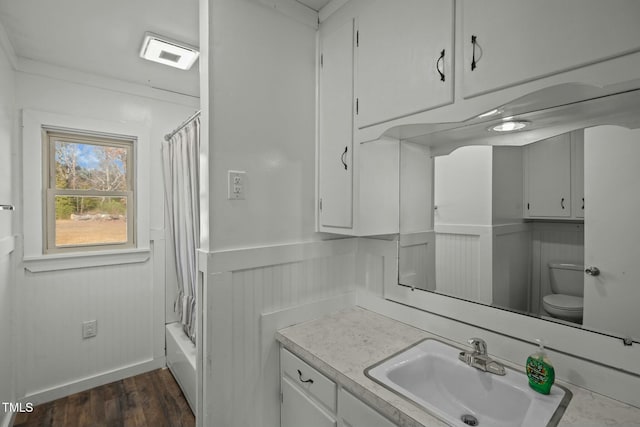 full bathroom with hardwood / wood-style floors, vanity, toilet, and shower / bath combo