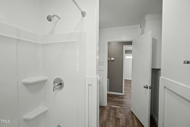 bathroom with a shower and wood-type flooring