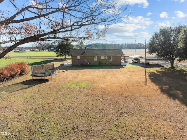 view of yard with a trampoline