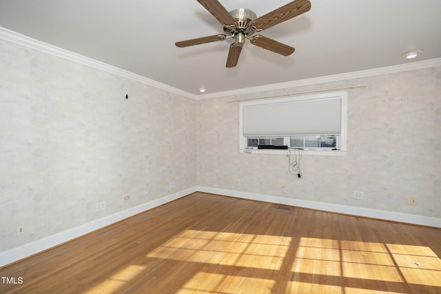 spare room with crown molding and hardwood / wood-style flooring