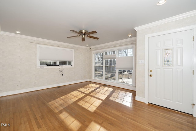 unfurnished living room with ceiling fan, hardwood / wood-style floors, and ornamental molding