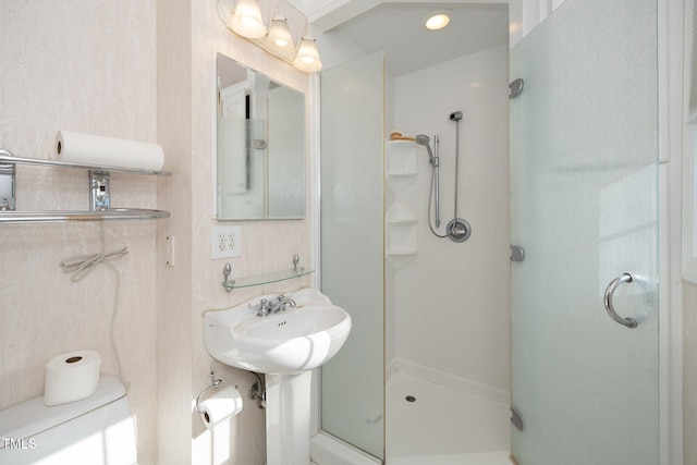 bathroom featuring a shower with shower door