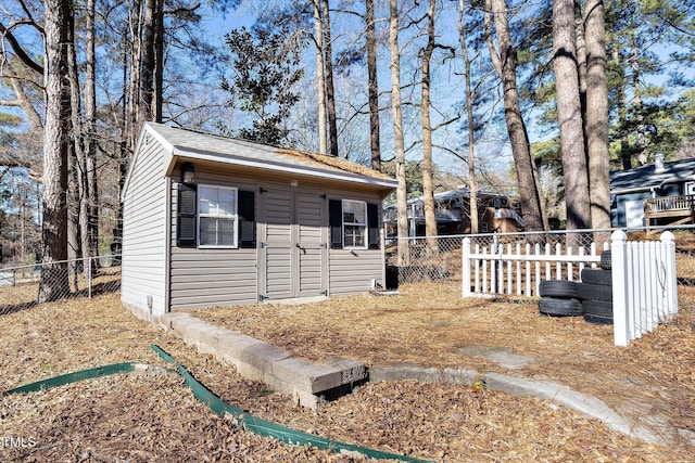 view of home's exterior with an outbuilding