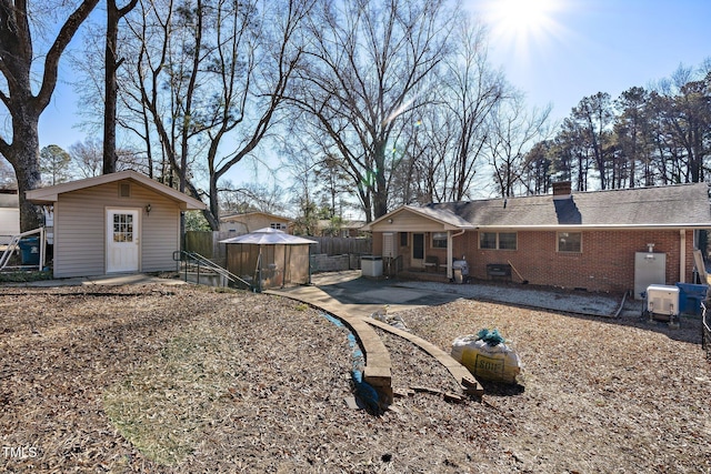 rear view of house featuring a shed and a patio