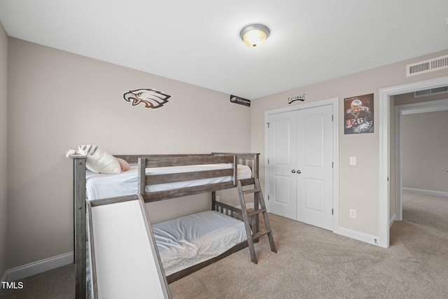 bedroom with carpet and a closet