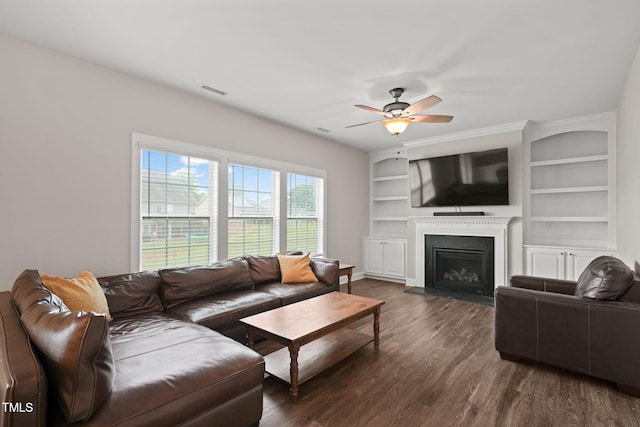 living room with ceiling fan, dark hardwood / wood-style flooring, and built in features