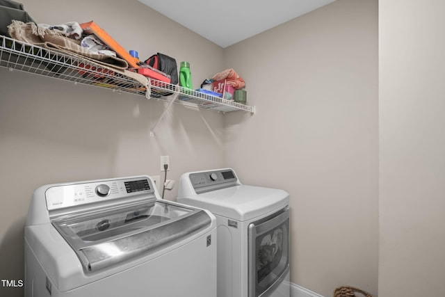 clothes washing area with independent washer and dryer