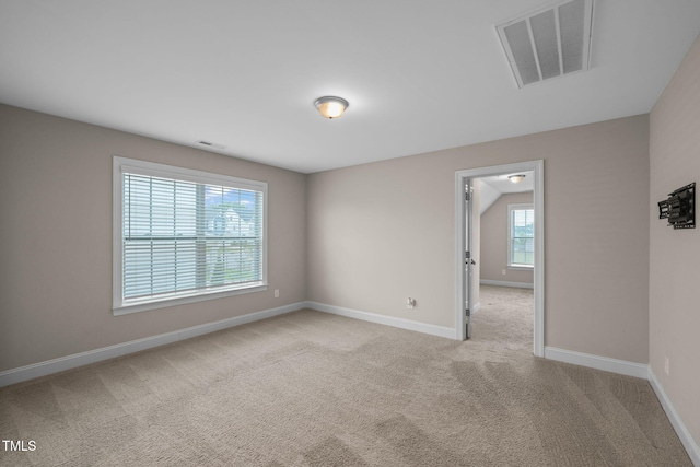 unfurnished room featuring light colored carpet