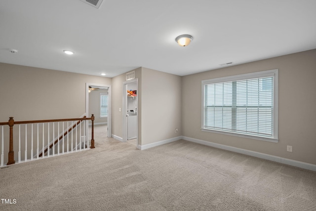 unfurnished room with light carpet