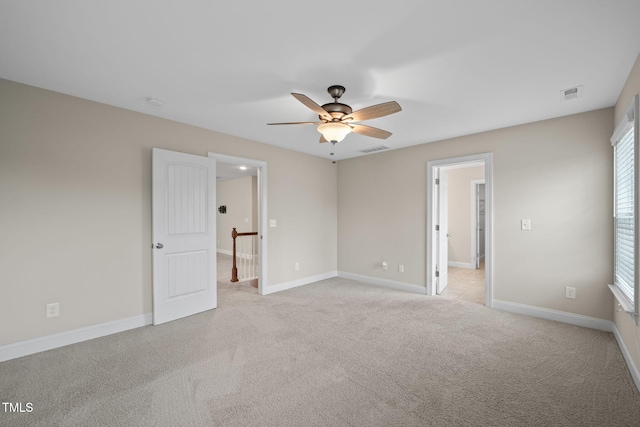 unfurnished bedroom with ceiling fan and light colored carpet