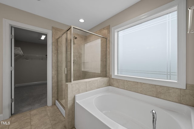 bathroom featuring tile patterned flooring and plus walk in shower