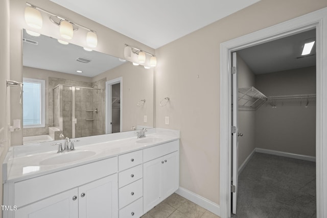 bathroom with tile patterned floors, vanity, and a shower with shower door