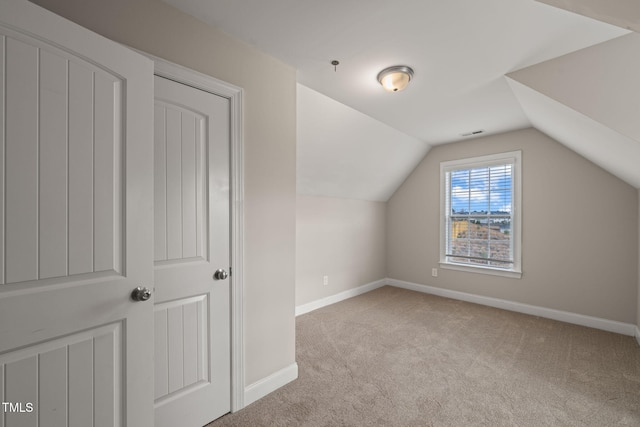 additional living space with light carpet and lofted ceiling