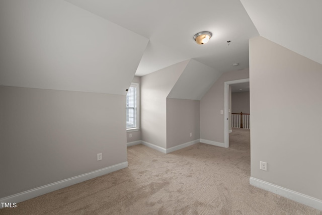 additional living space with light carpet and lofted ceiling