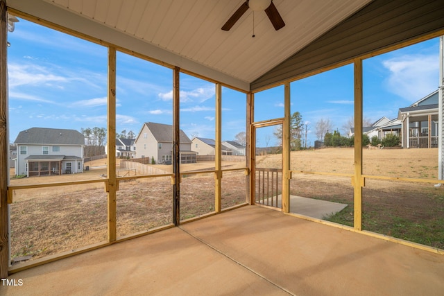 unfurnished sunroom featuring ceiling fan and vaulted ceiling