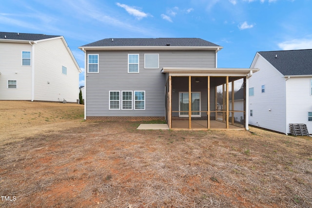 back of house with a lawn and a sunroom