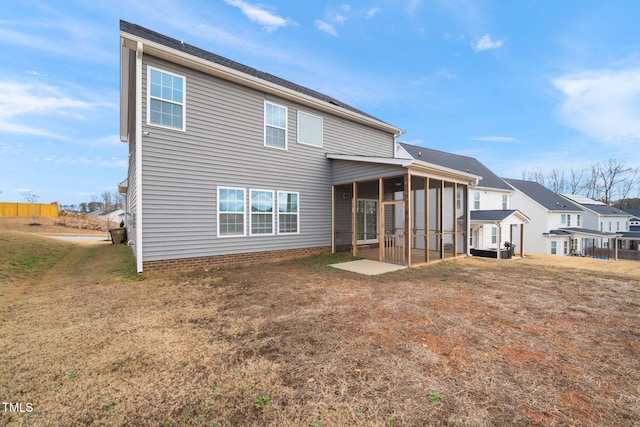 back of house featuring a sunroom