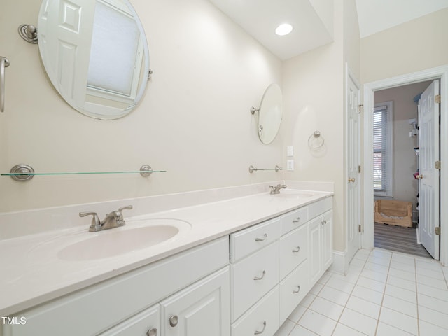 full bathroom featuring double vanity, tile patterned flooring, a sink, and recessed lighting