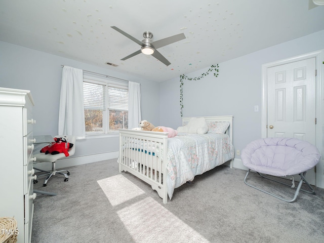 bedroom with carpet floors, ceiling fan, visible vents, and baseboards