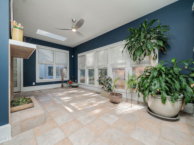 sunroom with a skylight and ceiling fan