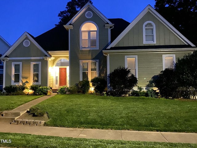 view of front facade with a front lawn and board and batten siding