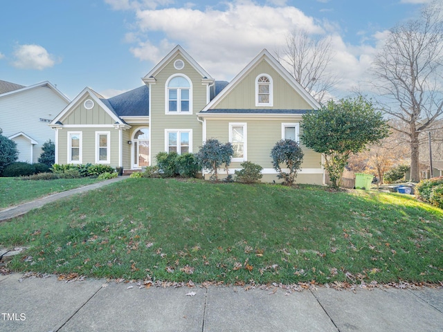 traditional home with a front lawn and board and batten siding