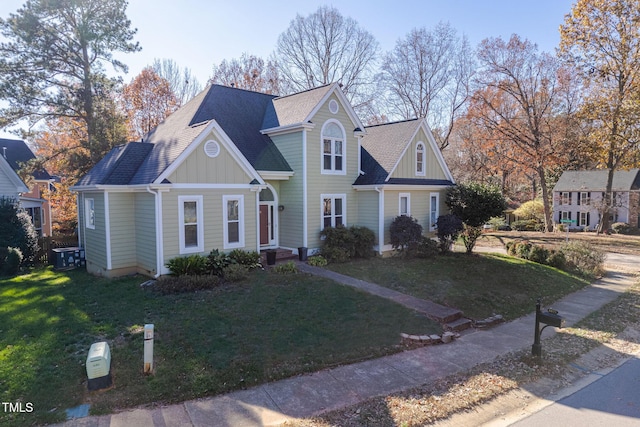 view of front of home featuring a front lawn, board and batten siding, and roof with shingles