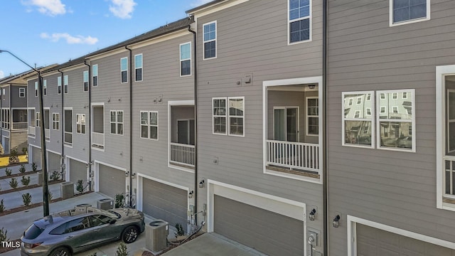 back of house with central AC unit