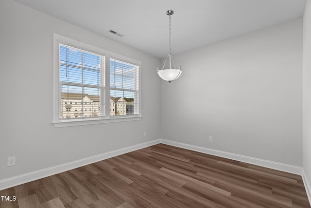 empty room with dark hardwood / wood-style floors