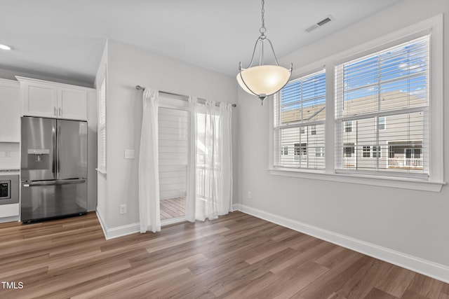 unfurnished dining area with hardwood / wood-style flooring