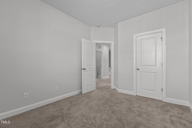 unfurnished bedroom featuring light carpet