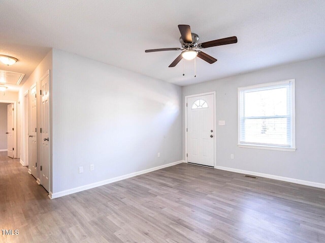 foyer entrance featuring wood-type flooring and ceiling fan