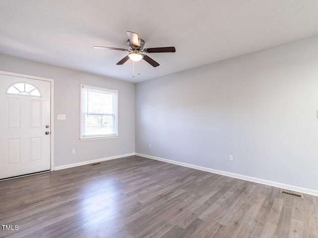 entrance foyer with hardwood / wood-style flooring, ceiling fan, and a textured ceiling