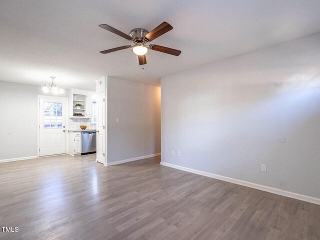 unfurnished living room featuring ceiling fan with notable chandelier and light wood-type flooring