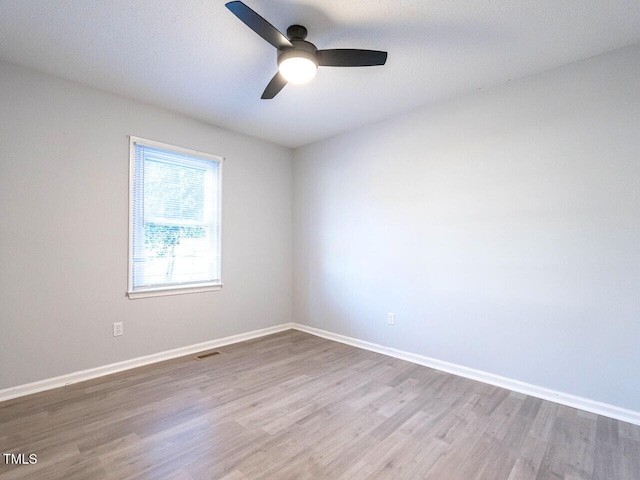 unfurnished room with light hardwood / wood-style flooring and ceiling fan