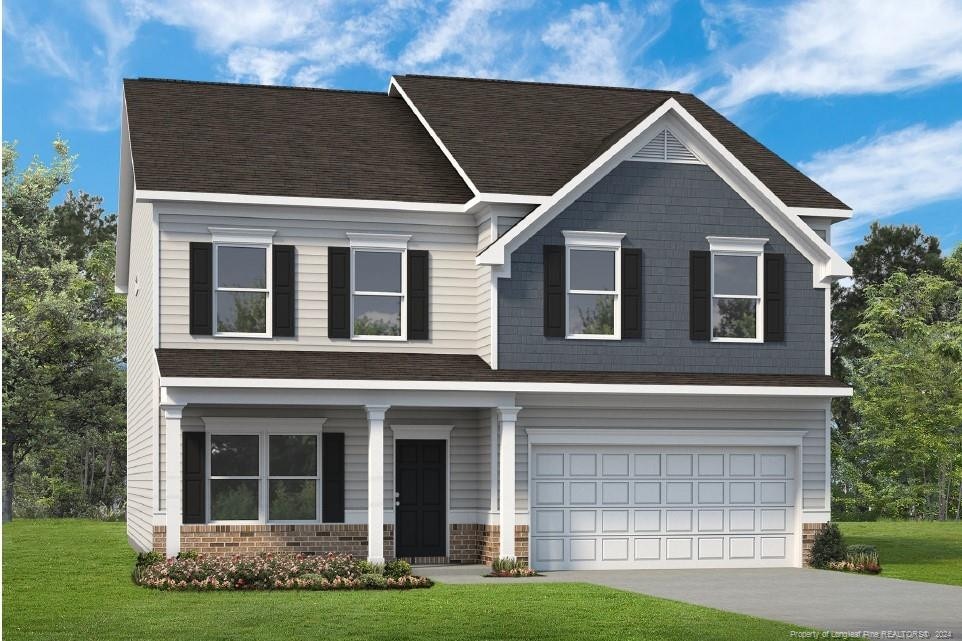 craftsman house with a front yard and a garage