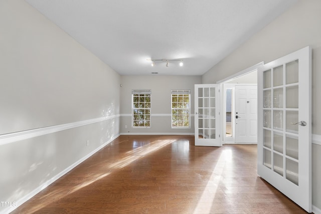 empty room with french doors and wood-type flooring