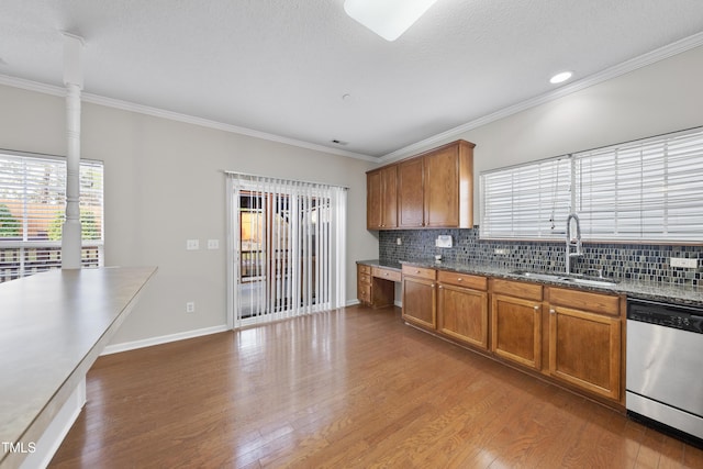 kitchen with sink, stainless steel dishwasher, dark hardwood / wood-style floors, crown molding, and decorative backsplash