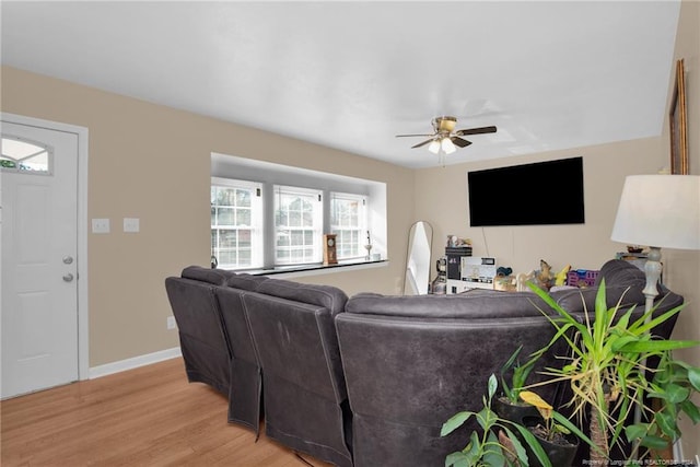 living room featuring light wood-type flooring, a wealth of natural light, and ceiling fan