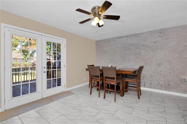 dining room featuring ceiling fan and french doors