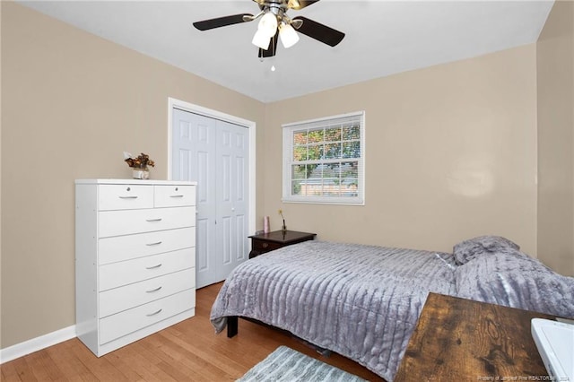 bedroom with hardwood / wood-style floors, ceiling fan, and a closet