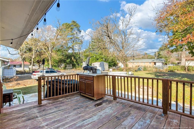 wooden terrace with a lawn