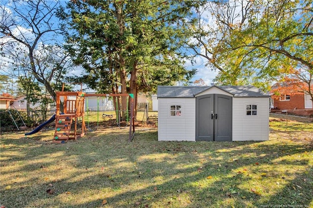 view of outdoor structure with a playground and a lawn